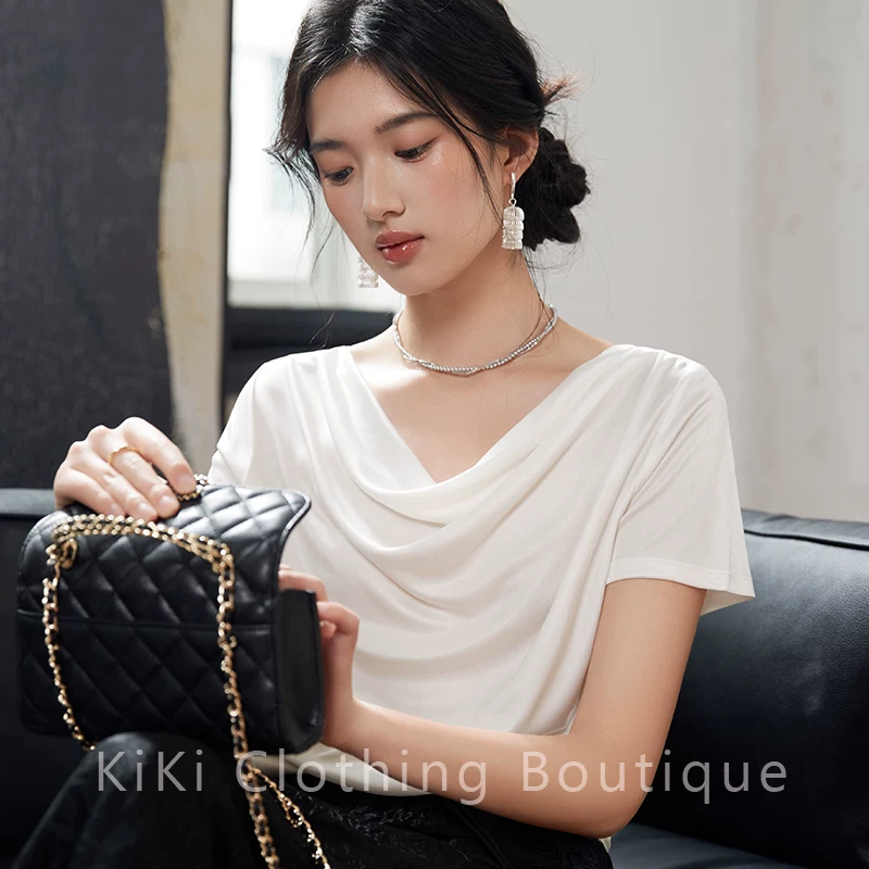 Домашняя silky наслаждение Kiki? и звучит awkward. But translate: "Kiki homemade silky enjoyment_Spring and summer white short-sleeved T-shirt acetic collar one-length elegant top for women"