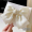 Beige bow spring clip