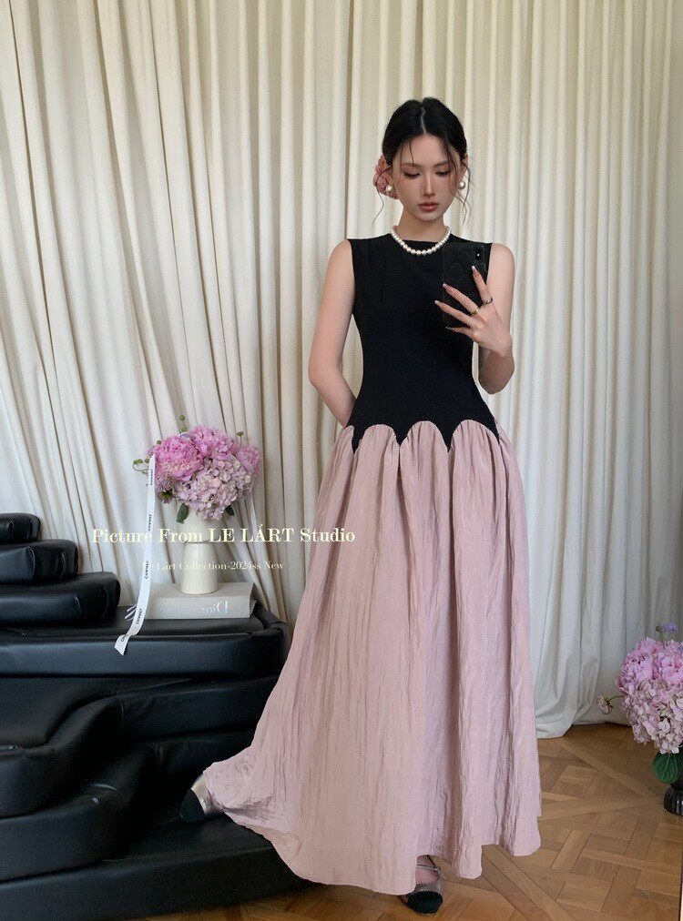 Sleeveless black-and-blush long dress worn by a model