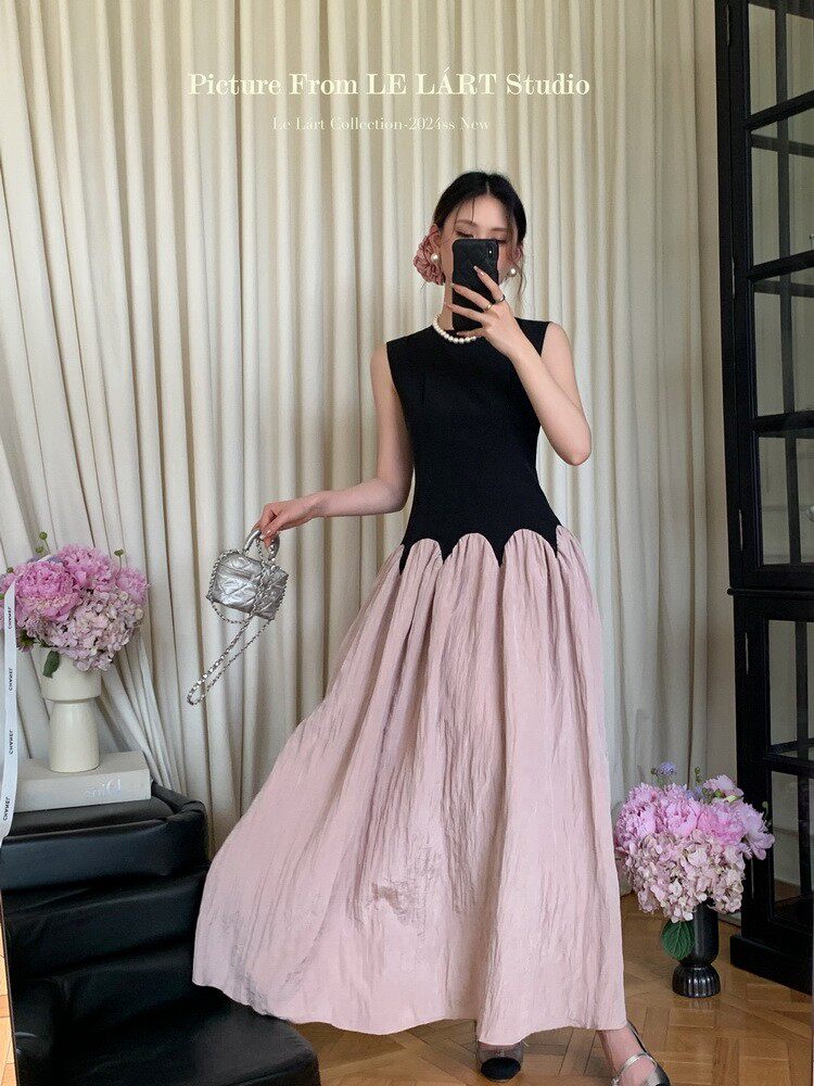 Model wearing a black and blush pink sleeveless maxi dress