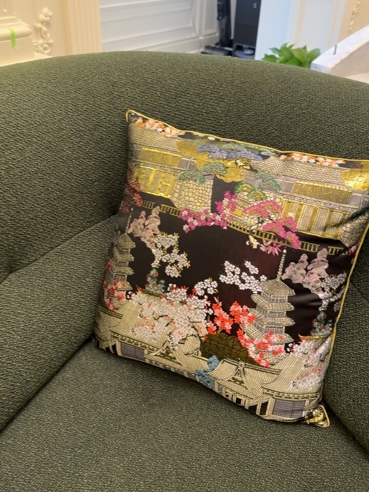 Chinoiserie pillow cover with gold tassel trim and black accent border on wine red velvet base