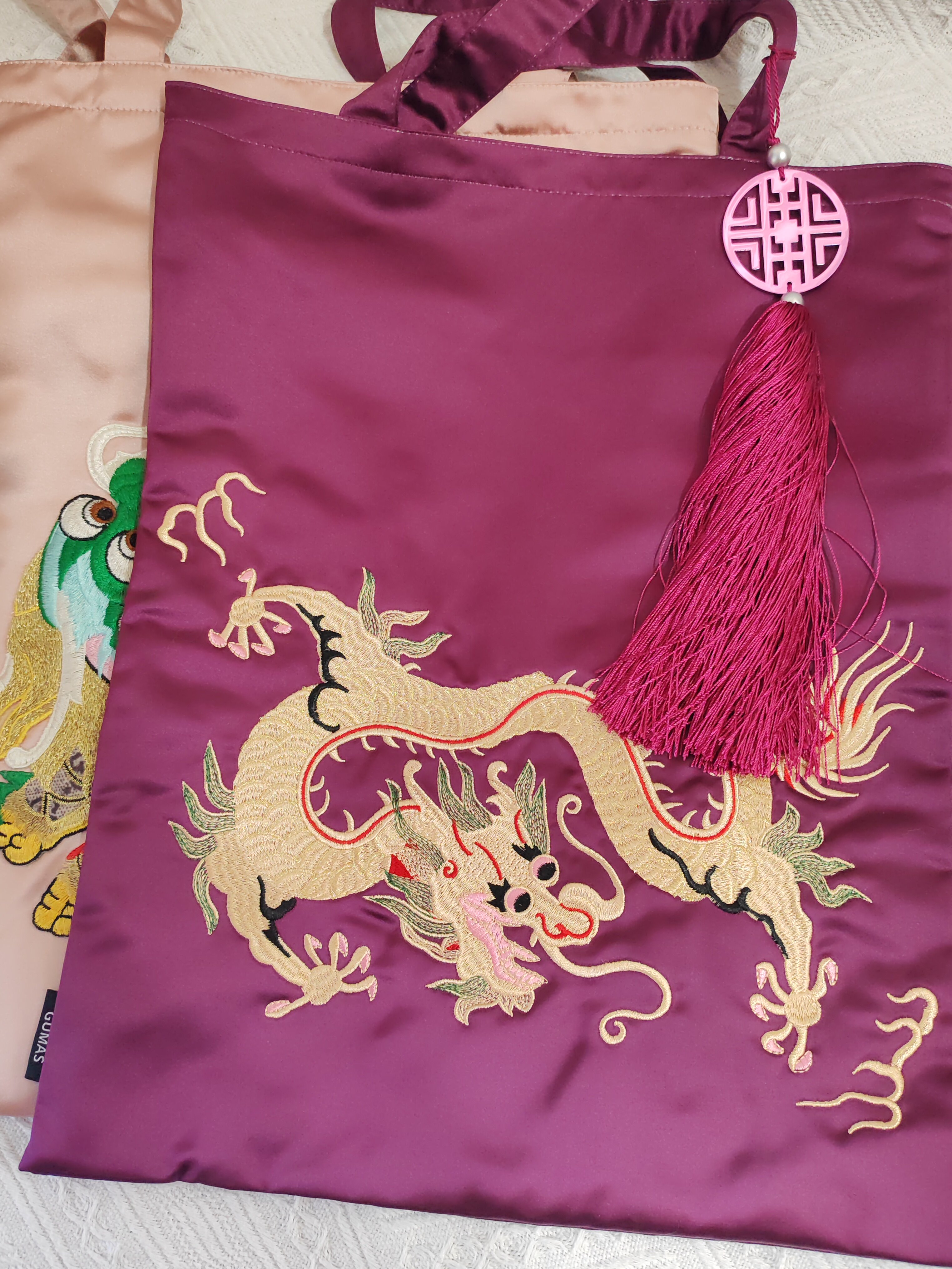 Close-up of dimensional hand-embroidered flowers on lime green silk decorative bag