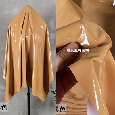 taobao agent Earth yellow khaki color superb surface elastic mirror leather fabric soft and delicate imitation leather reflective waterproof PU cloth