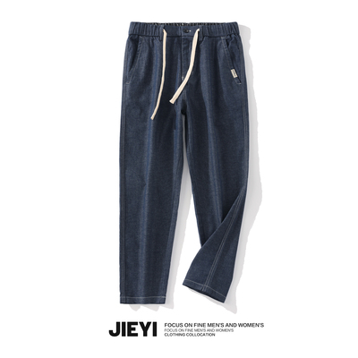 taobao agent Jieyi loose waist drawing rope to make old jeans, men's workers, American Water Washing trousers stickers inside printed pants