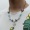 Жемчужное ожерелье с маргариткой и бабочкой