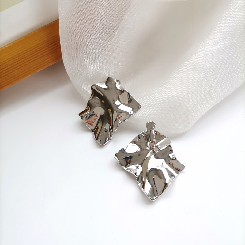 A pair of silver ear clips
