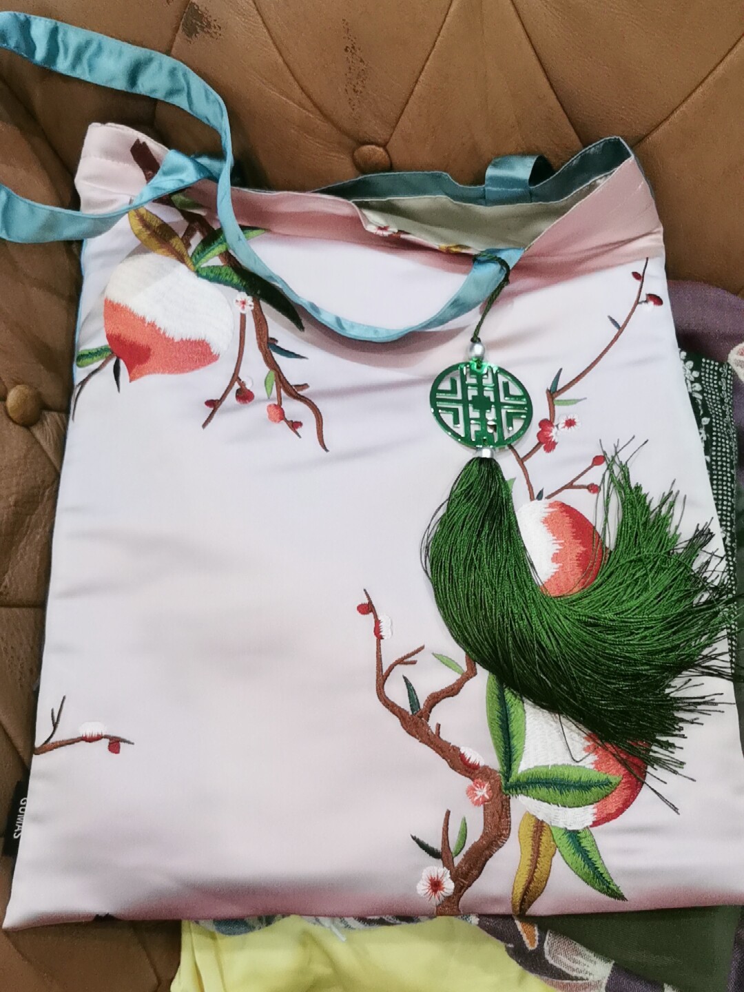 Luxury silk gift pouch in bright green with traditional Chinese floral embroidery