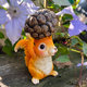 Little squirrel lifts pine cones and decorative ornaments cute animals home desktop decoration balcony outdoor gardening landscaping arrangement