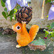 Little squirrel lifts pine cones and decorative ornaments cute animals home desktop decoration balcony outdoor gardening landscaping arrangement