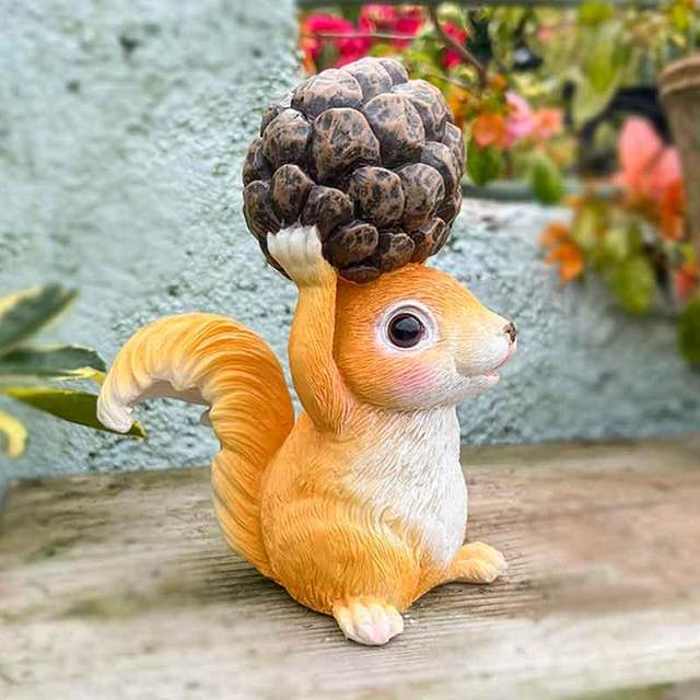Little squirrel lifts pine cones and decorative ornaments cute animals home desktop decoration balcony outdoor gardening landscaping arrangement