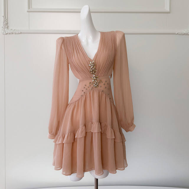 
French niche fashion 2025 design sense hollow rhinestone champagne powder long sleeve V-neck waist-hugging vacation dress for women