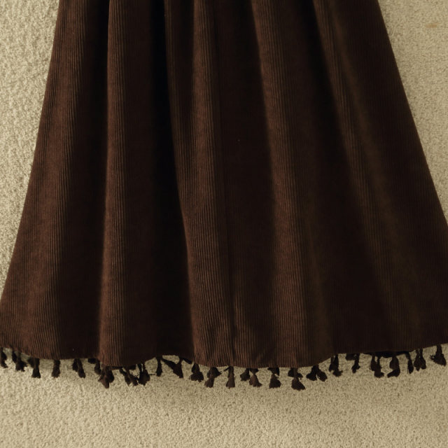 Retro corduroy skirt for women in autumn and winter new high-waisted slim button decorative tassel large a-line sling umbrella skirt