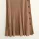 Spring and Autumn Pit knitted half skirt solid color button decoration simple temperament medium long A -line skirt outer single -tail cargo women's clothing