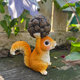 Little squirrel lifts pine cones and decorative ornaments cute animals home desktop decoration balcony outdoor gardening landscaping arrangement