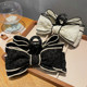 Black bow grabbing a large high -level high -level high -level hair clip female back head hair card elegant temperament shark clip headdress
