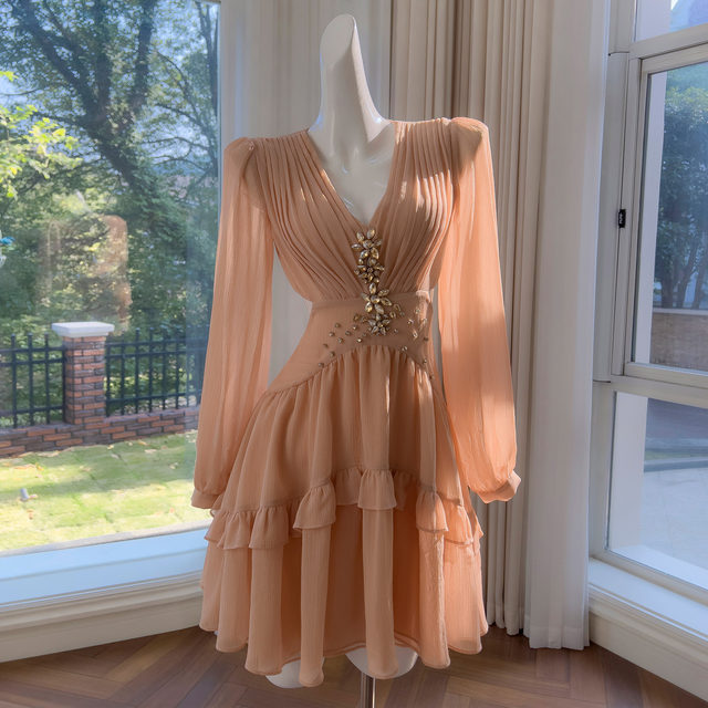 
French niche fashion 2025 design sense hollow rhinestone champagne powder long sleeve V-neck waist-hugging vacation dress for women