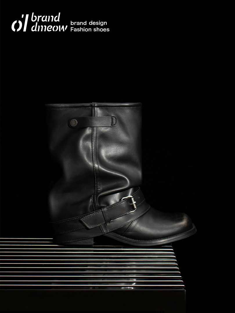 Black leather mid-calf buckle boots displayed on a dark background