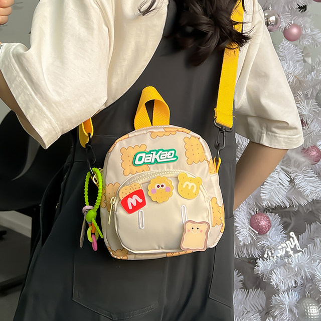 ຖົງນ້ອຍສໍາລັບແມ່ຍິງ 2024 ພາກຮຽນ spring ໃຫມ່ biscuit ພໍ່ແມ່-ເດັກນ້ອຍ backpack canvas crossbody bag casual versatile outing shoulder bag