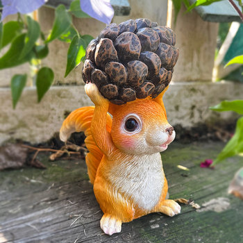 Little squirrel holding pine cone decorative ornament