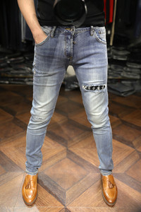 Milan fashion show style, damaged lining, diamond embellishments, embroidered silver stars, slim fit, elastic slim leg jeans, men
