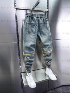 Trendy men's ankle tied Harlan pants are popular on the internet, with elastic waist and small leg pants in blue washed and distressed patchwork jeans