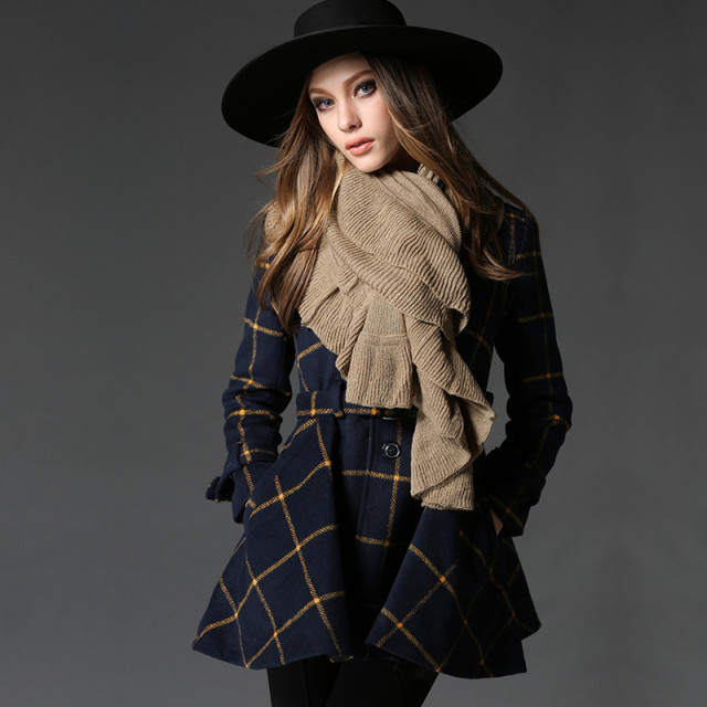 Woman wearing a tartan scarf with a wool coat