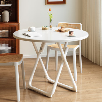 Simple modern round dining table that can be folded and takes up no space